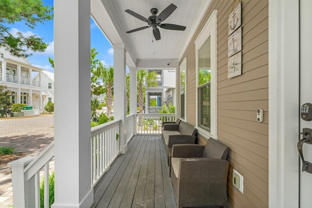 wooden deck with covered porch and ceiling fan