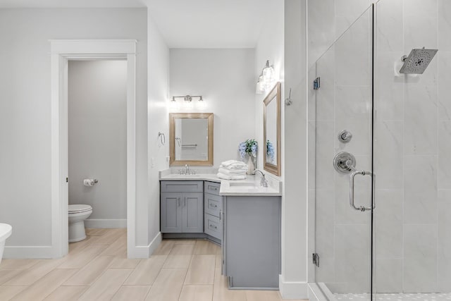 bathroom featuring vanity, walk in shower, and toilet