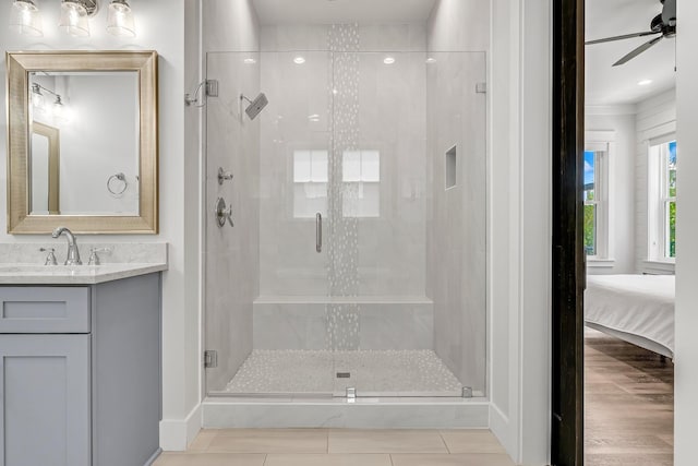 bathroom with vanity, ceiling fan, and a shower with shower door