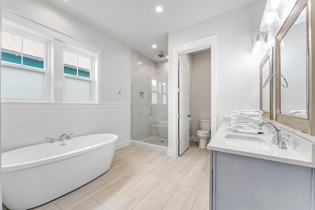 full bathroom featuring toilet, vanity, and shower with separate bathtub