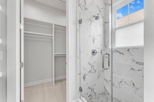 bathroom with tile patterned floors and a shower with shower door