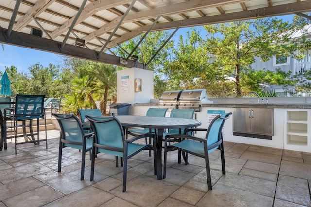 view of patio / terrace with a bar, a grill, an outdoor kitchen, and a gazebo