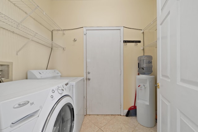 clothes washing area featuring separate washer and dryer and light tile patterned floors