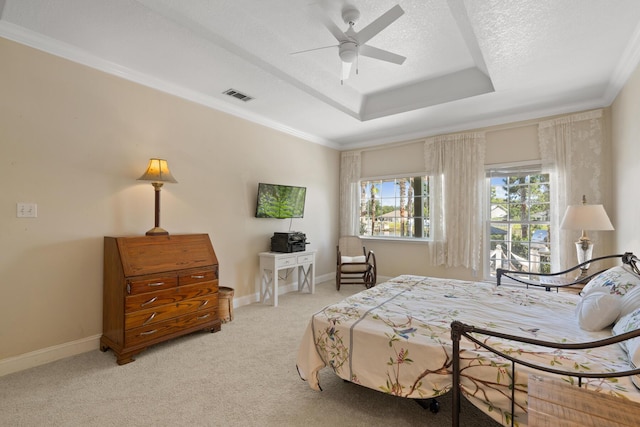 bedroom featuring light carpet, ornamental molding, a raised ceiling, and a textured ceiling