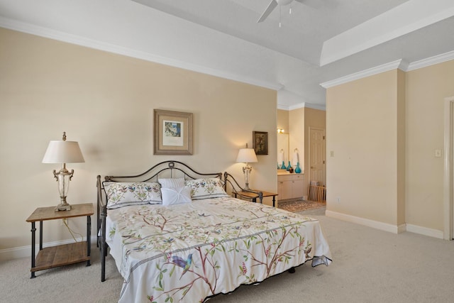 carpeted bedroom with crown molding and ensuite bathroom