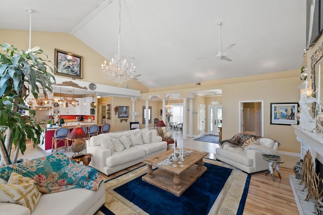 living room with ceiling fan, high vaulted ceiling, light hardwood / wood-style floors, and ornate columns