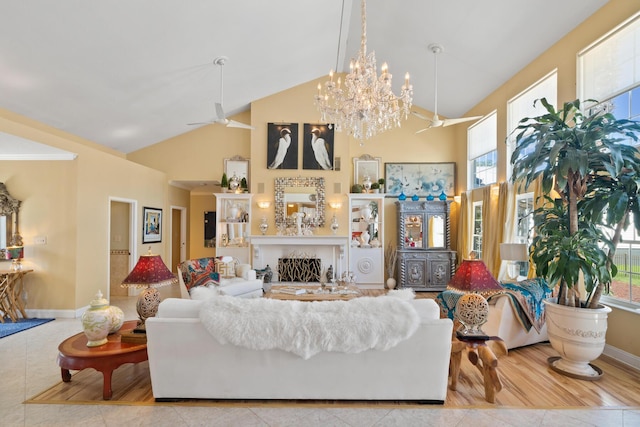 living room featuring ceiling fan and high vaulted ceiling