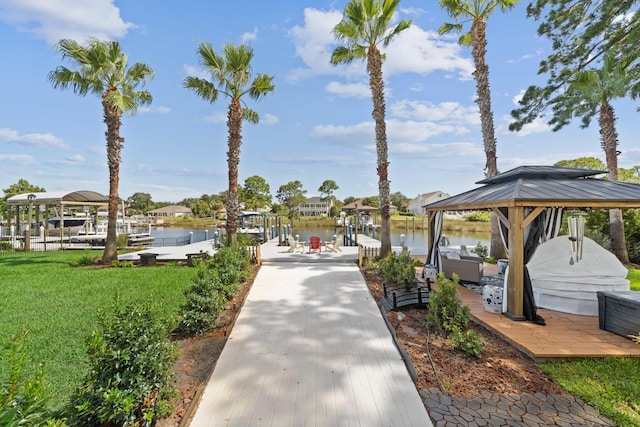 view of dock featuring a lawn and a water view