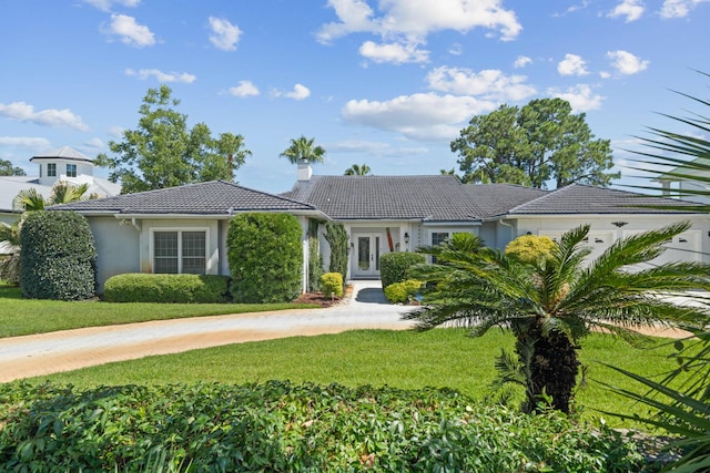 mediterranean / spanish-style home with a front lawn