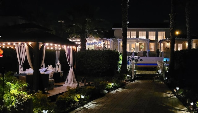 yard at twilight with a gazebo