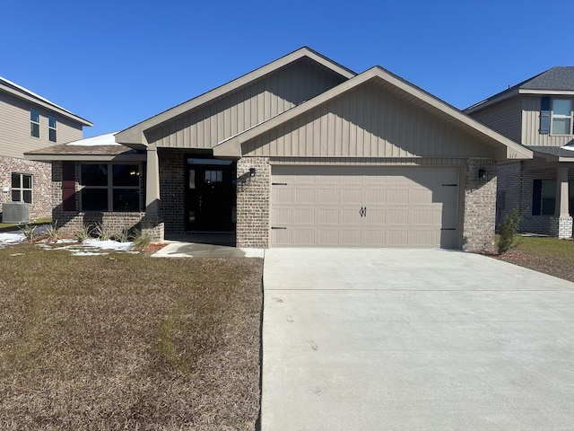 craftsman-style house with a garage, central AC unit, and a front yard