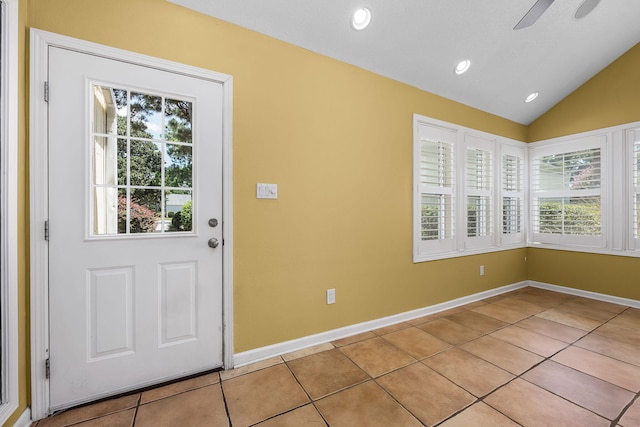 interior space with a ceiling fan, baseboards, light tile patterned flooring, recessed lighting, and vaulted ceiling