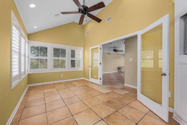 tiled spare room featuring high vaulted ceiling, french doors, and ceiling fan