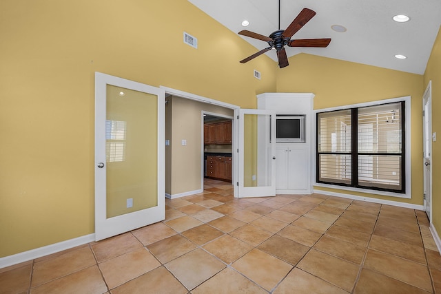 unfurnished living room with light tile patterned floors, ceiling fan, and high vaulted ceiling