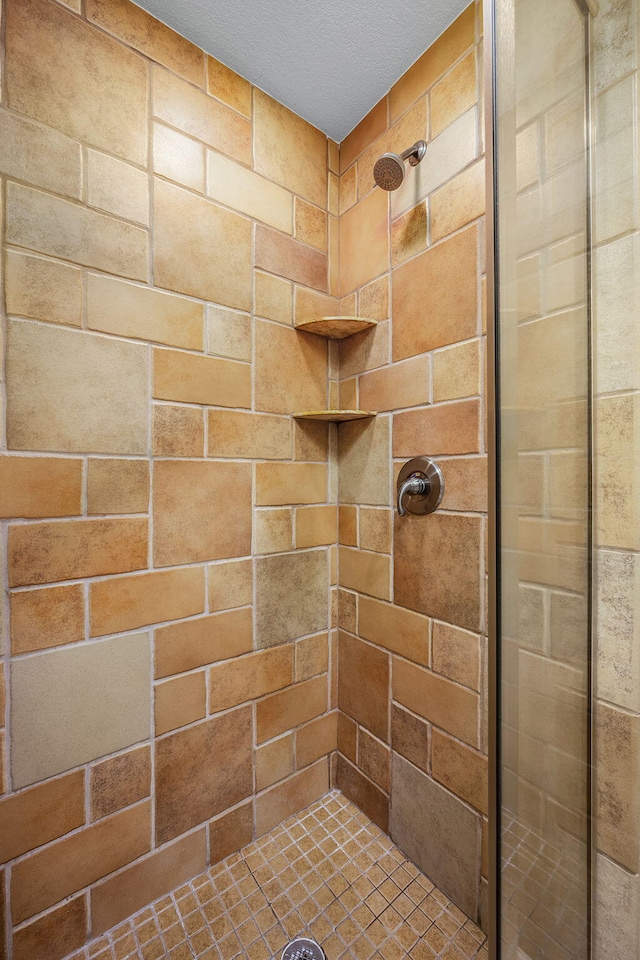 bathroom with a tile shower