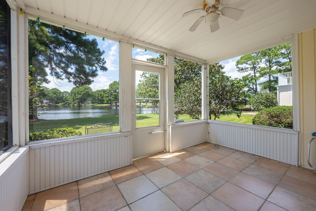 unfurnished sunroom featuring a water view and ceiling fan