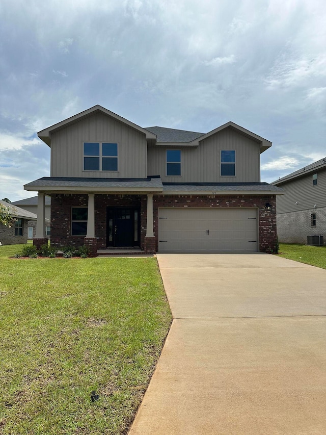 view of front of house featuring cooling unit, a garage, and a front lawn