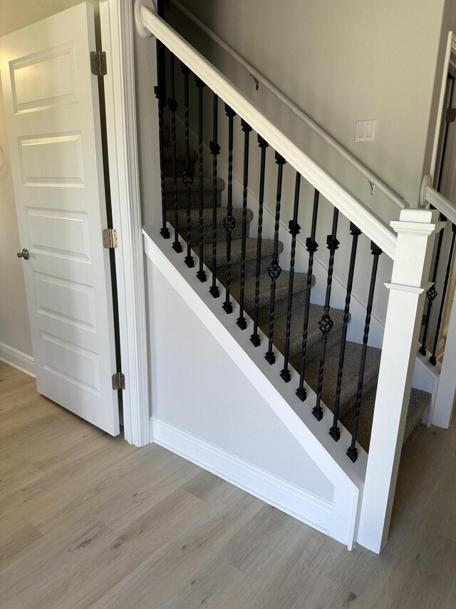 stairway with light wood-type flooring