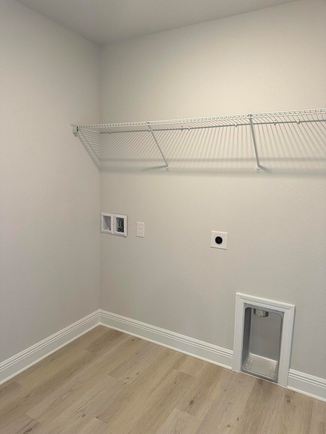 washroom featuring hookup for an electric dryer, hardwood / wood-style flooring, and hookup for a washing machine