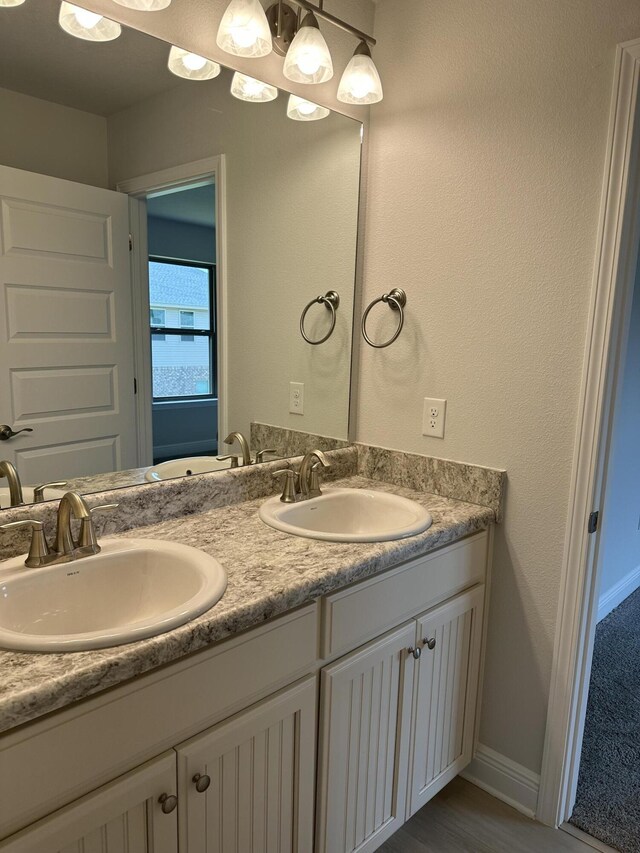 bathroom featuring dual vanity