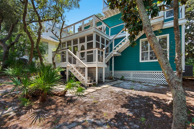 rear view of property featuring a sunroom