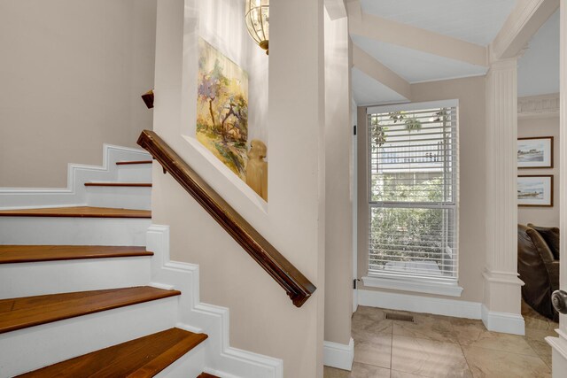 stairs featuring light tile patterned floors