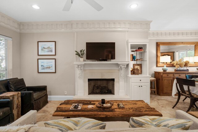 living area with a ceiling fan, a high end fireplace, and recessed lighting