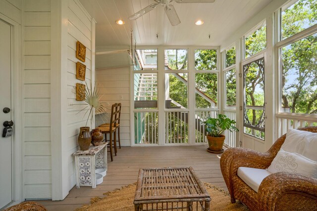 sunroom / solarium featuring ceiling fan