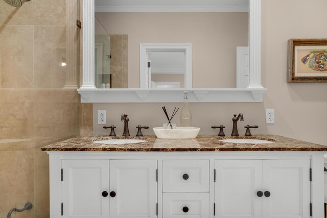 bathroom featuring crown molding and dual bowl vanity