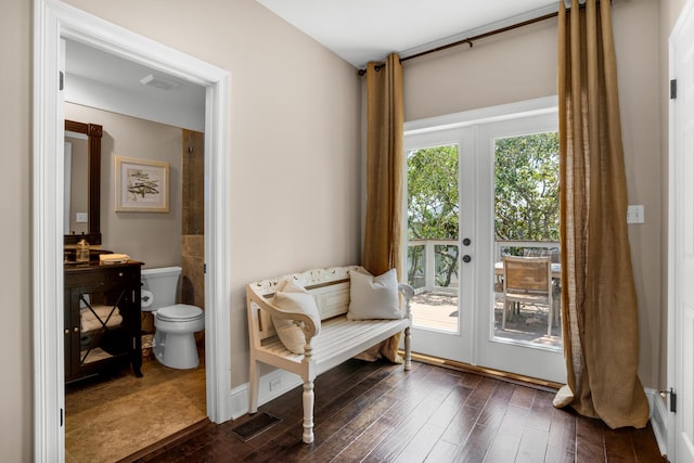 living area with french doors, dark wood-type flooring, and visible vents