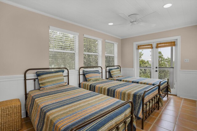 bedroom featuring access to outside, ceiling fan, multiple windows, and tile patterned floors