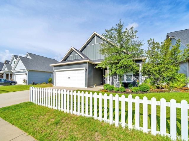 craftsman inspired home featuring a garage and a front yard