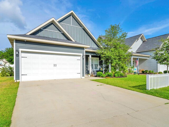 craftsman house featuring a garage and a front lawn