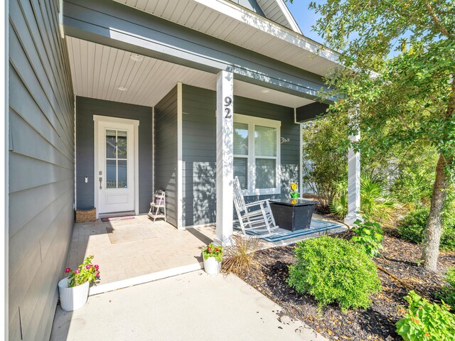 view of exterior entry with a porch