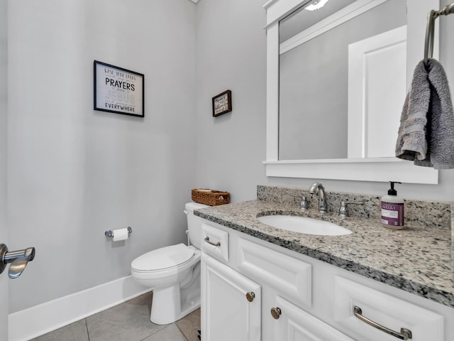 bathroom featuring tile patterned floors, toilet, and vanity