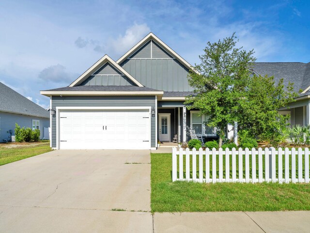 craftsman house featuring a garage and a front lawn