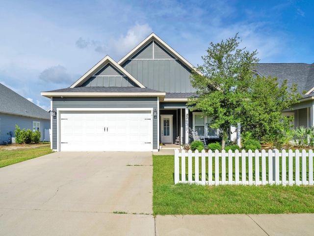 craftsman house featuring a garage and a front lawn