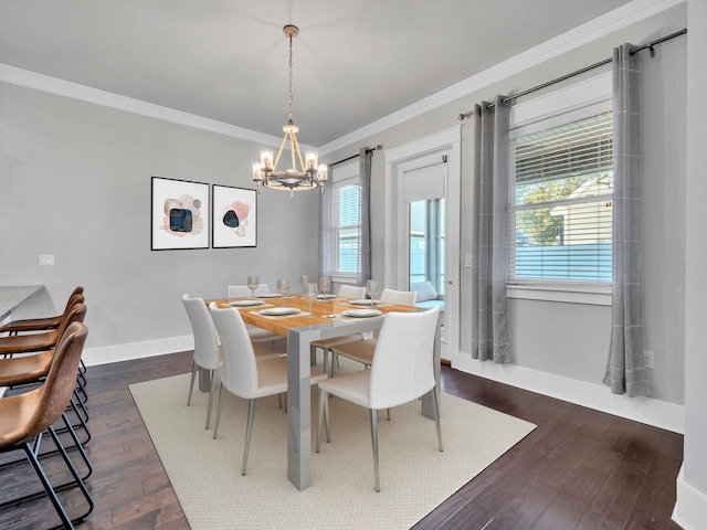 dining room featuring crown molding, dark wood-type flooring, and a chandelier