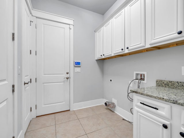 laundry area featuring washer hookup, light tile patterned floors, cabinets, and hookup for an electric dryer