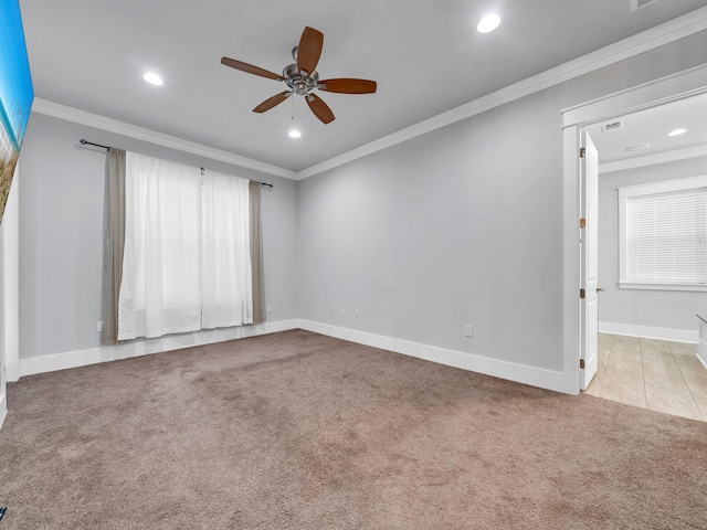 carpeted empty room with ornamental molding and ceiling fan