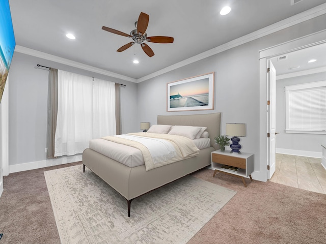 carpeted bedroom featuring crown molding and ceiling fan