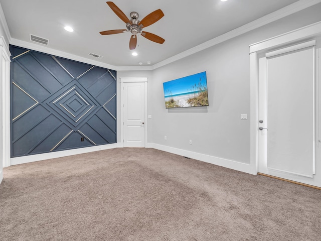 carpeted spare room with ornamental molding and ceiling fan