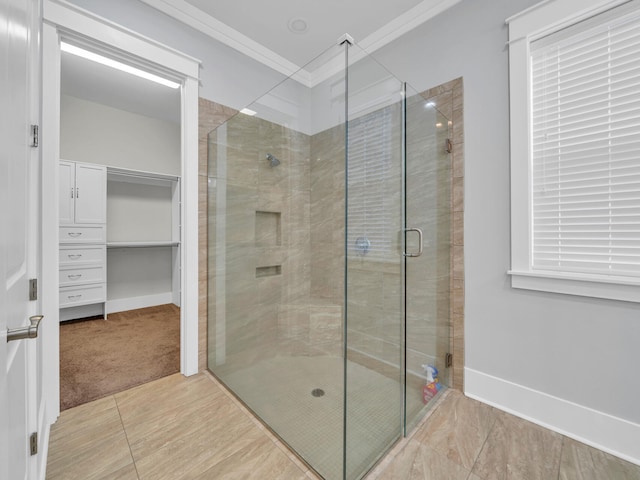 bathroom featuring tile patterned floors, a shower with shower door, and ornamental molding