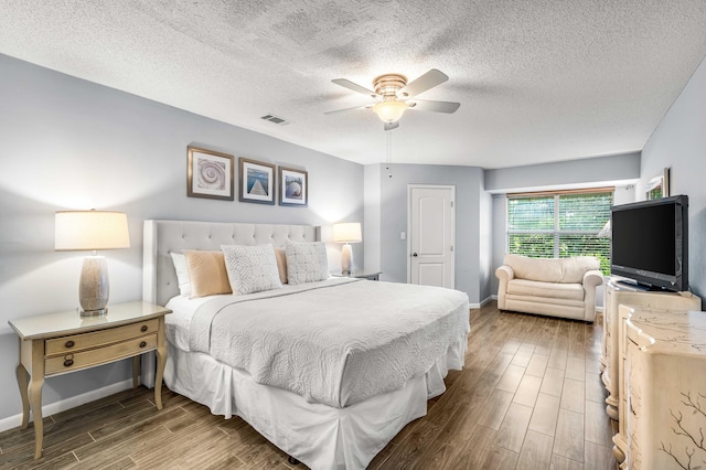 bedroom featuring hardwood / wood-style floors, a textured ceiling, and ceiling fan