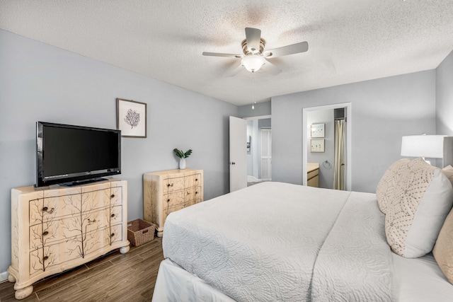 bedroom featuring hardwood / wood-style flooring, ceiling fan, ensuite bathroom, and a textured ceiling