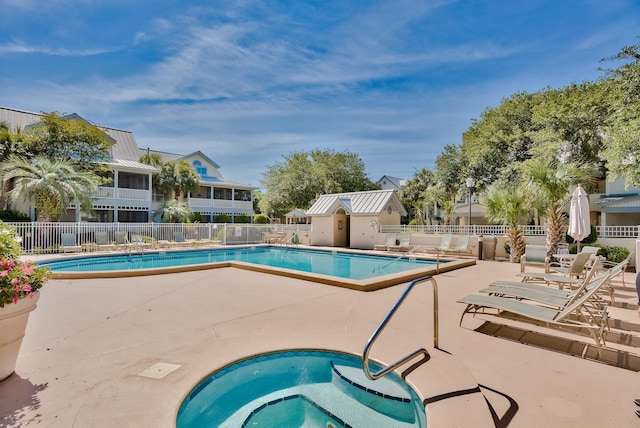 view of pool featuring a community hot tub and a patio area