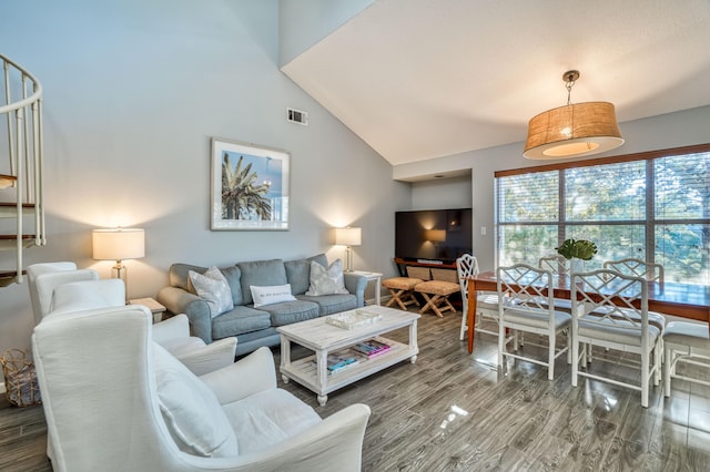 living room with high vaulted ceiling and hardwood / wood-style floors