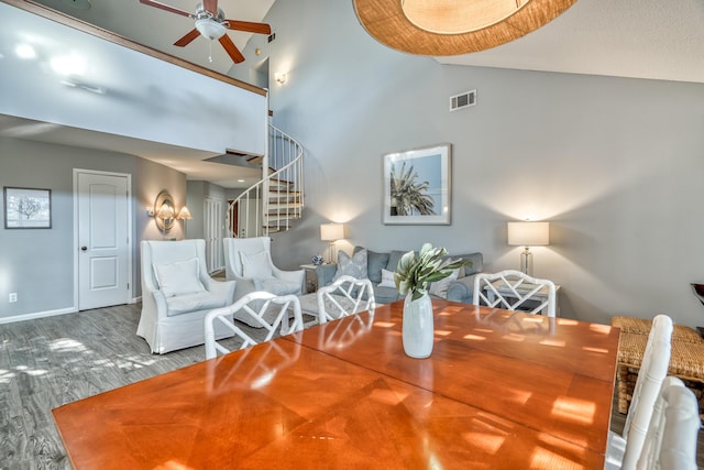 dining room featuring ceiling fan, high vaulted ceiling, and hardwood / wood-style floors