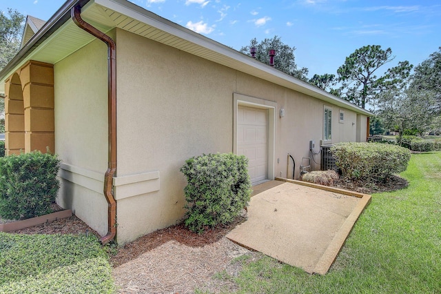 view of side of property with a garage and a yard