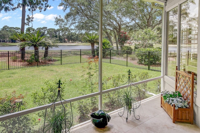 unfurnished sunroom featuring a water view